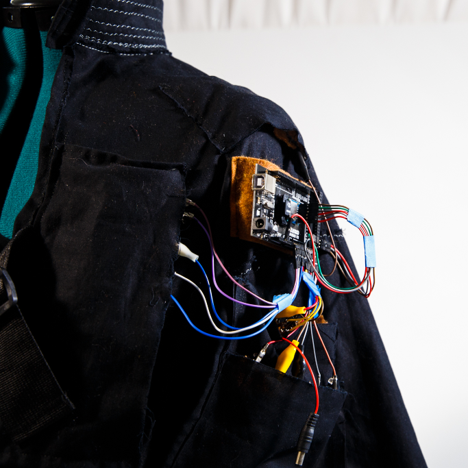 view of inside out jacket shoulder showing microcontroller and circuit connections
