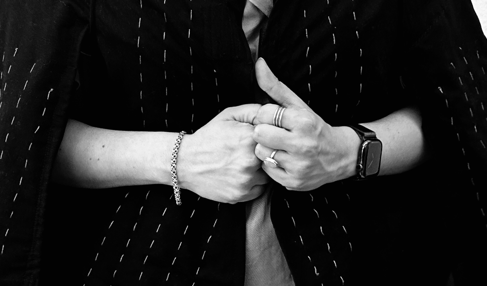 view of jacket wearer's hands hanging onto its front